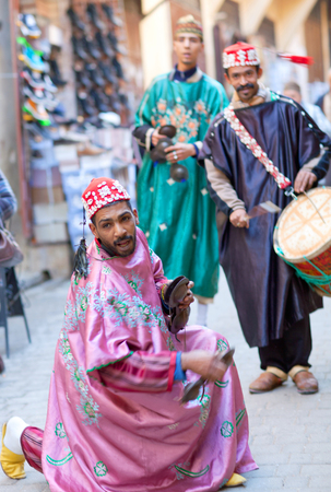 FEZ, MOROCCO - JANUARY 14, 2014: Musicians playing traditional instruments in the street for tourists and shoppers in Fez Medinaのeditorial素材