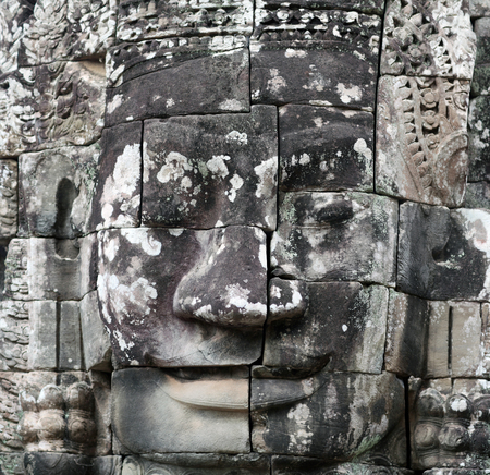 Stone face - Ancient relief of Prasat Bayon temple (late 12th - early 13th century) in Angkor Thom, Cambodiaの写真素材