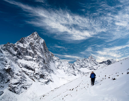 An unidentified hiker walking on the road to Everest Base Camp in Sagarmatha National Park, Nepal Himalayaの写真素材