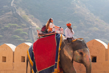 JAIPUR, RAJASTHAN, INDIA - JANUARY 14, 2019: Tourists riding on elephant in Amber fort, Rajasthan state. Elephant rides are popular tourist attraction in Amber Fortのeditorial素材