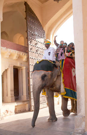 JAIPUR, RAJASTHAN, INDIA - JANUARY 14, 2019: Tourists riding on elephant in Amber fort, Rajasthan state. Elephant rides are popular tourist attraction in Amber Fortのeditorial素材