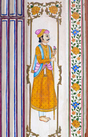 UDAIPUR, RAJASTHAN, INDIA - JANUARY 8, 2019: Honorable Indian man in traditional clothes - ancient wall painting at old Haveli. A haveli is a traditional townhouse or mansion in India.のeditorial素材