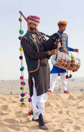 BIKANER, INDIA - JANUARY 12, 2019: Indian band in traditional clothes performing during Camel festival in Thar desert in Rajasthan state.のeditorial素材