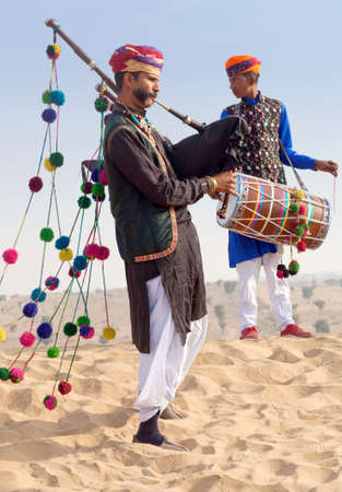 BIKANER, INDIA - JANUARY 12, 2019: Indian band in traditional clothes performing during Camel festival in Thar desert in Rajasthan state.のeditorial素材