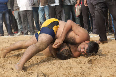 BIKANER, INDIA - JANUARY 12, 2019: Indian wrestlers doing their practice during Camel festival in Rajasthan. Pehlwani, or kushti is a form of wrestling from the Indian subcontinent.のeditorial素材