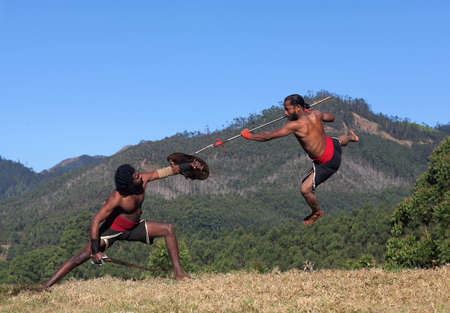 Indian fighters performing Aayudha Payattu (Weapon Combat) during Kalaripayattu Marital art demonstration in Kerala, South Indiaの写真素材