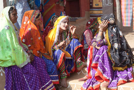 UDAIPUR, INDIA - JANUARY 7, 2019: Indian Rajasthani women in traditional clothes selling beads at local market, Rajasthan stateのeditorial素材
