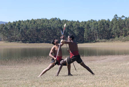 Indian fighters performing Aayudha Payattu (Weapon Combat) during Kalaripayattu Marital art demonstration in Kerala, South Indiaの写真素材