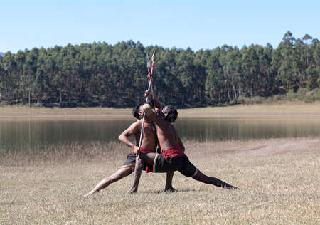 Indian fighters performing Aayudha Payattu (Weapon Combat) during Kalaripayattu Marital art demonstration in Kerala, South Indiaの写真素材