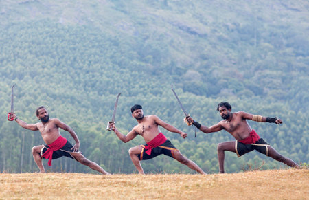 Indian fighters jumping up during Kalaripayattu Marital art demonstration in Kerala, South India