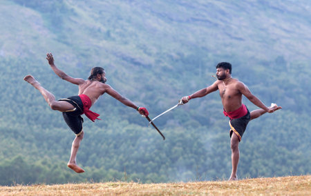Indian fighters performing Aayudha Payattu (Weapon Combat) during Kalaripayattu Marital art demonstration in Kerala, South Indiaの写真素材