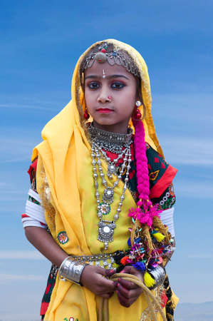 BIKANER, INDIA - JANUARY 12, 2019: Indian girl in national clothes poses for a photo during Camel Festival in Rajasthanのeditorial素材