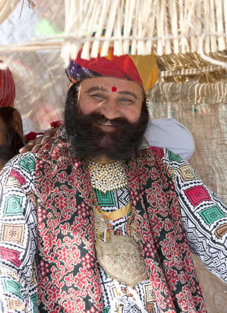 BIKANER, INDIA - JANUARY 12, 2019: Indian smiling Rajasthani man with long mustache poses for a photo during Camel Festival in Rajasthanのeditorial素材