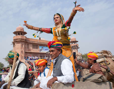 BIKANER, INDIA - JANUARY 12, 2019: Indian girl in traditional clothes dancing at festival in Rajasthan state. The Camel Festival begins with a colourful procession of camels, musicians and dancersのeditorial素材