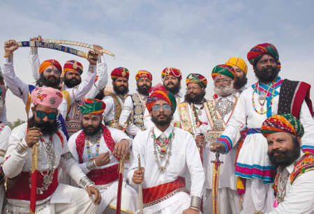 BIKANER, INDIA - JANUARY 11, 2019: Indian men with a long mustaches in national clothes poses for a photo during Camel Festival in Rajasthanのeditorial素材