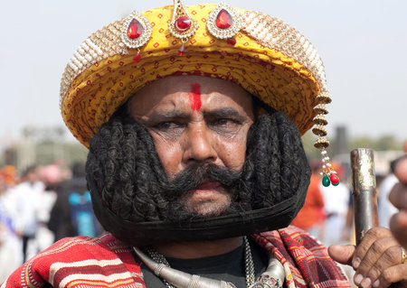 BIKANER, INDIA - JANUARY 11, 2019: Indian man presenting his famous long mustache during Camel...