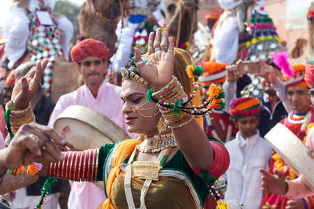 BIKANER, INDIA - JANUARY 12, 2019: Indian dancer in traditional clothes dancing at festival in Rajasthan state. The Camel Festival begins with a colourful procession of camels, musicians and dancersのeditorial素材