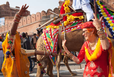 BIKANER, INDIA - JANUARY 12, 2019: People dancind on the street during festival in Rajasthan state. Camel Festival begins with a colourful procession of camels, musicians and dancersのeditorial素材
