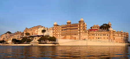Panoramic view of the Udaipur City Palace Complex from lake Pichola in Rajasthan, Indiaのeditorial素材