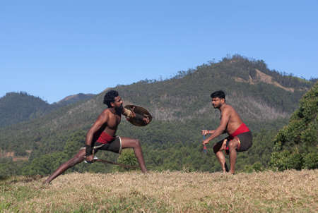 Indian fighters performing Kalaripayattu marital art demonstration in Kerala, South Indiaの写真素材