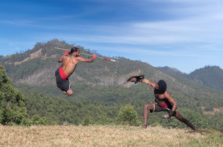 Indian fighters performing Kalaripayattu marital art demonstration in Kerala, South Indiaの写真素材