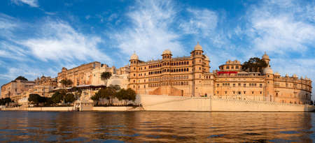 Panoramic view of the Udaipur City Palace Complex from lake Pichola in Rajasthan, Indiaのeditorial素材