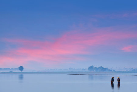 AMARAPURA, MYANMAR - JANUARY 2, 2020: Burmese women fishing on Thaungthaman Lake in Mandalay Divisionのeditorial素材