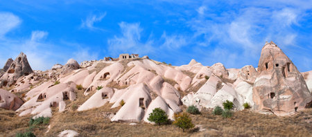 Panorama of unique geological formations in Pigeon valley in sunny day. Cappadocia, Central Anatolia, Turkey.の写真素材