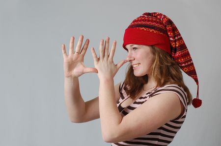 a woman in a xmas hat, teasing someoneの写真素材