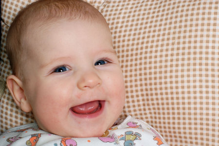 a very happy little baby, sincerely laughing