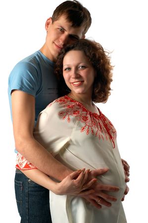 young father hugging his pregnant wife, isolated on whiteの写真素材