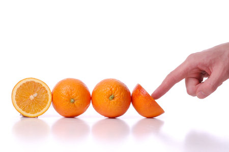 Use and pushes perfectly fresh oranges, on white backgroundの写真素材