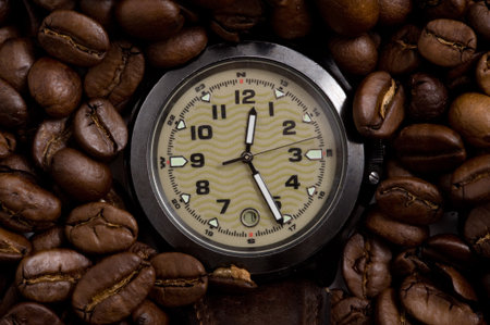 Closeup watch in the Lots of natural coffee beansの写真素材