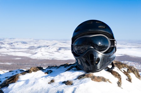 Helmet on mountains with blue sky in backgroundの写真素材