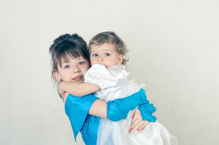 Two little sisters. Shot in studio.の写真素材