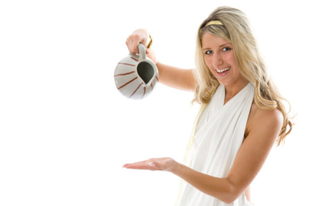 The young attractive girl pours milk from a jug. Close-up portrait isolated on white backgroundの写真素材