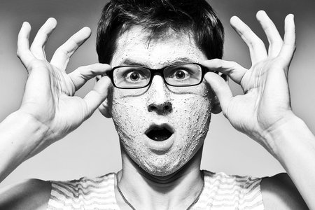 Close-up portrait of funny man with facial mask and glasses