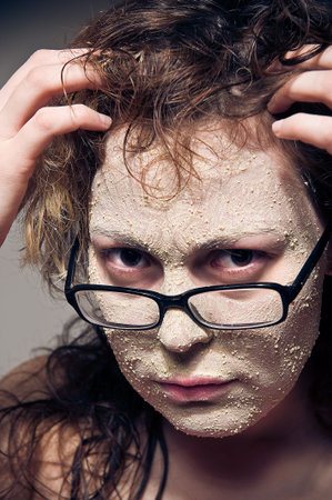 Close-up portrait of funny girl with facial mask. の写真素材