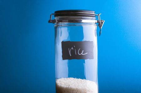 Inscription "Rise" on transparent glass jar. Over blue backgroundの写真素材