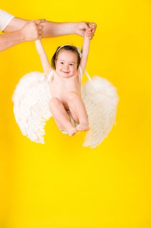 Fanny girl with angel wings on yellowの写真素材
