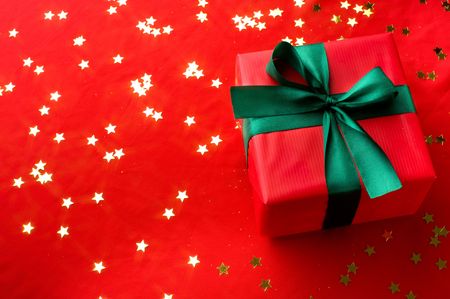 Close-up xmas gift over golden stars backgroundの写真素材