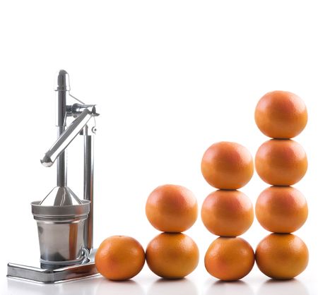 Small group of grapefruits isolated on white and a mechanical squezeerの写真素材