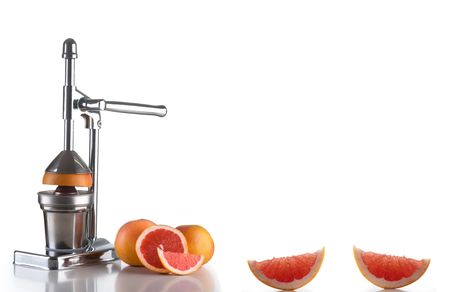 Small group of grapefruits isolated on white and a mechanical squezeerの写真素材