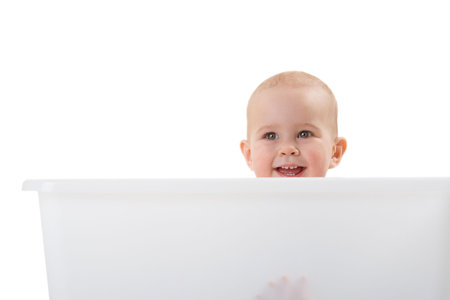 A young smiling girl in the big box over white backgroundの写真素材