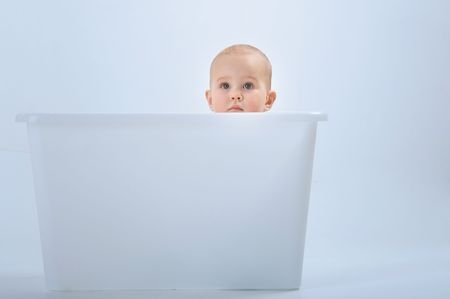 Eyes is a mirror of soul. A young curious girl in the big box. の写真素材