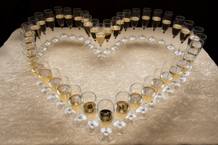 The heart symbol made of champagne glassesの写真素材