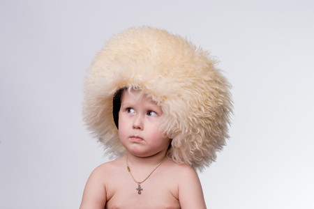 Portrait of a boy wearing funny furry winter hatの写真素材