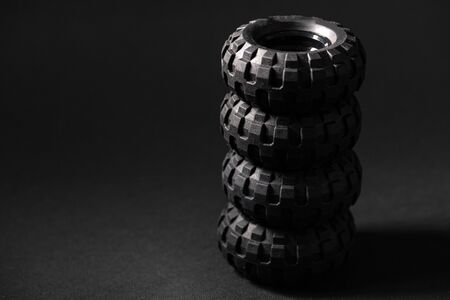 Stack of toy tires close up over black backgroundの写真素材