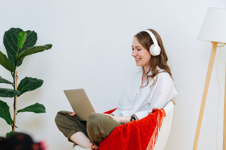 Laughing woman watching movie on her laptop and laughing