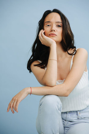 Portrait of a hot, beautiful brunette with serious face expression and white vitiligo eyelashes....
